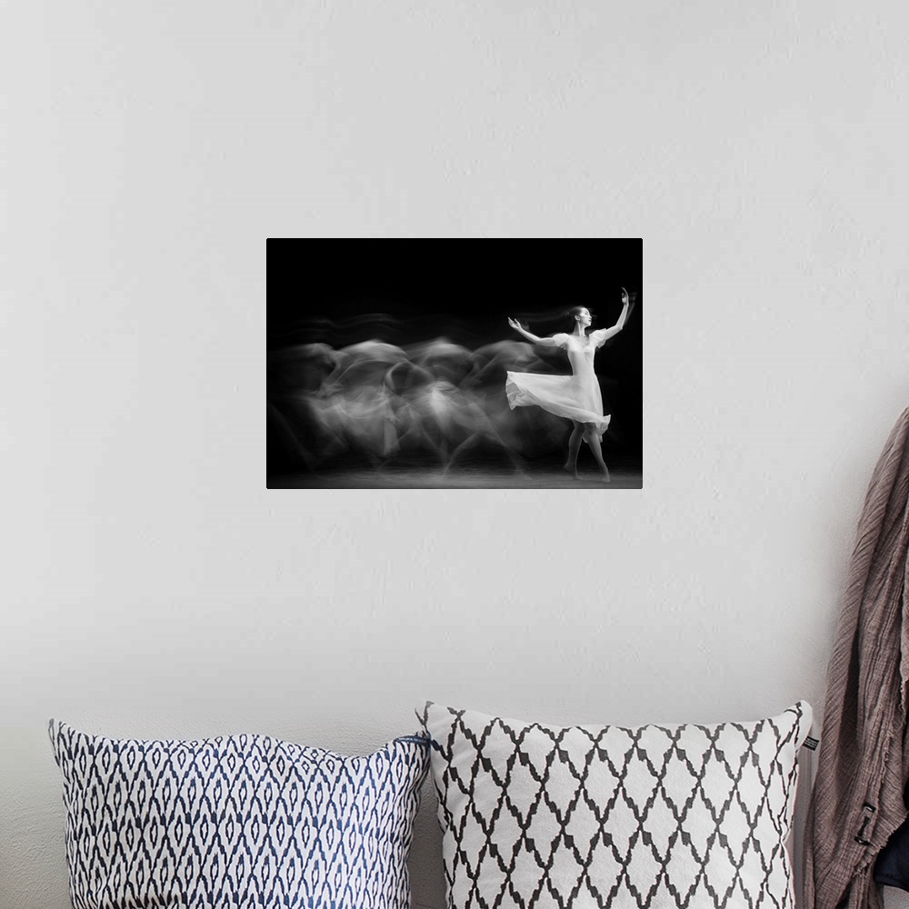 A bohemian room featuring A black and white multi-exposure photograph of a dancer wearing a white dress.