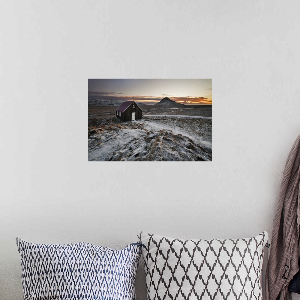 A bohemian room featuring Small church in the icy rural landscape of Iceland, during sunset.