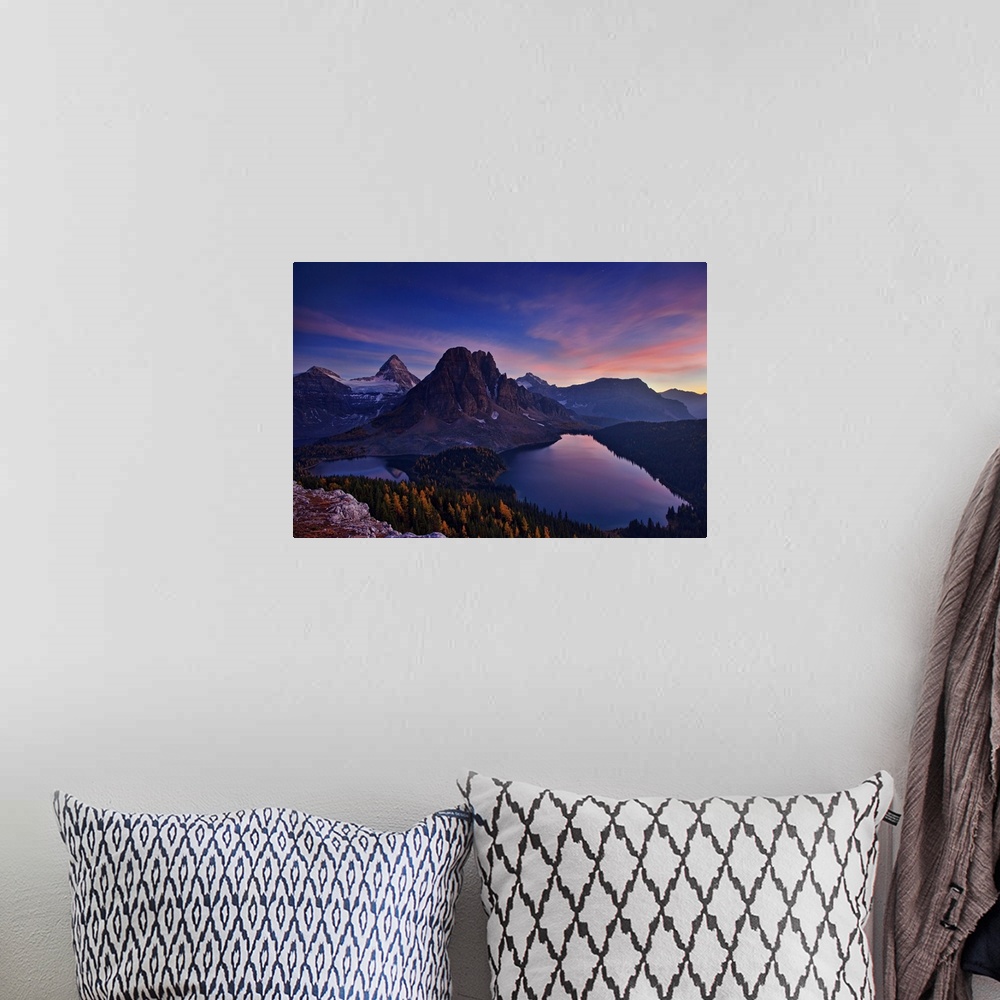 A bohemian room featuring View of two lakes and a snowy mountain range at sunset, with a pastel sky.