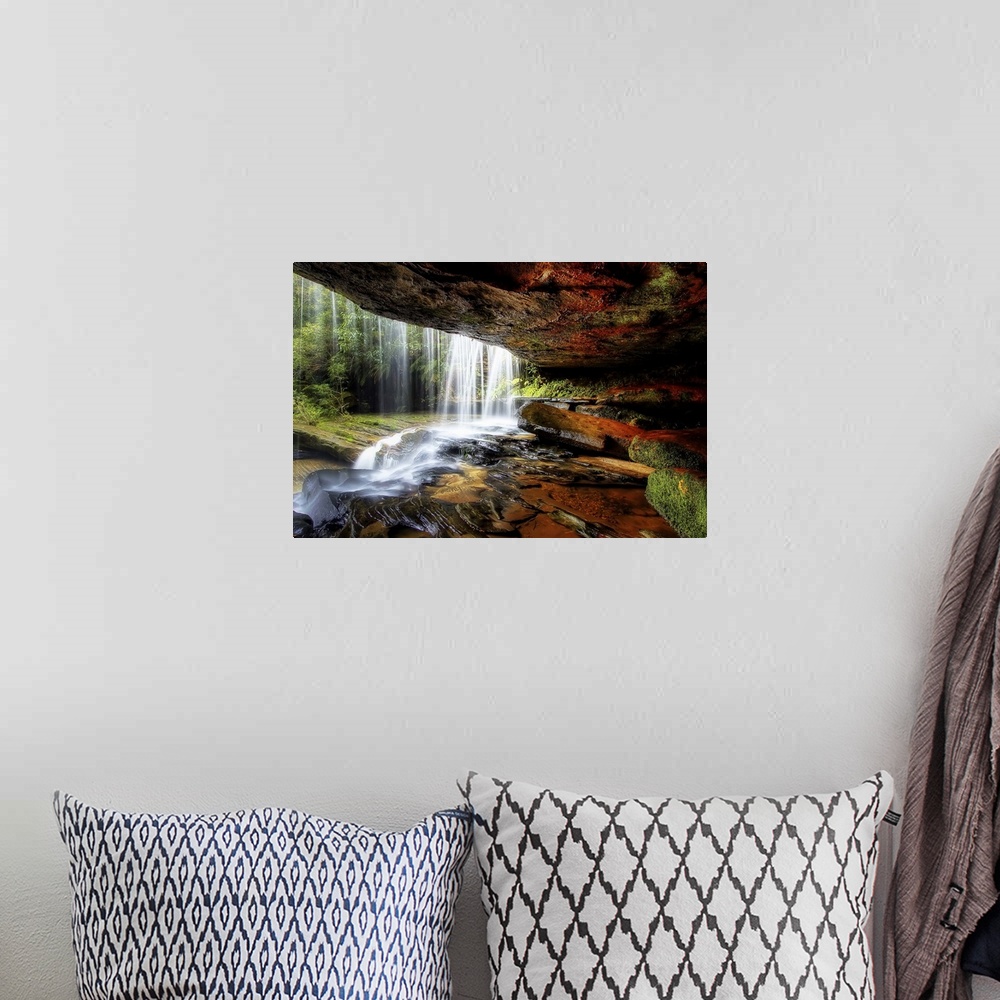 A bohemian room featuring A cave behind a waterfall with wet stones and moss.