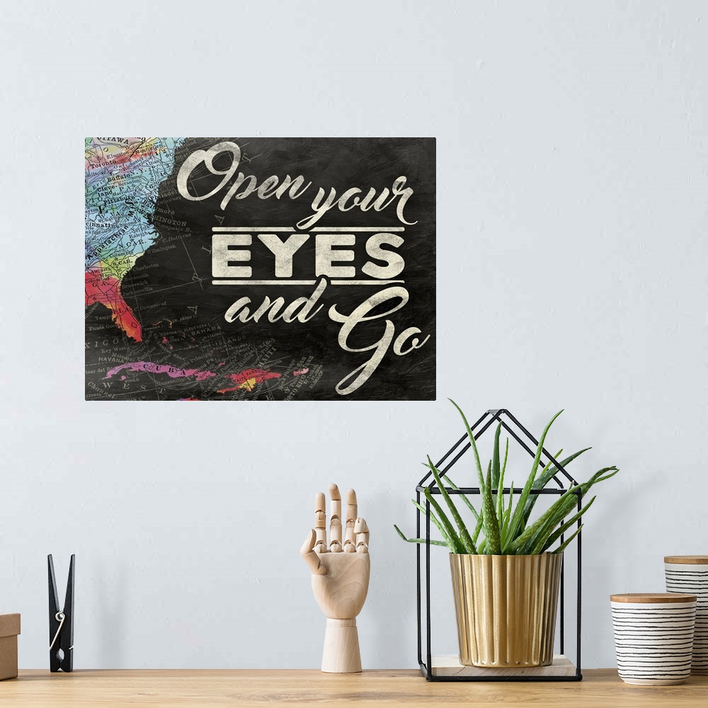 A bohemian room featuring "Open Your Eyes and Go" painted on a chalkboard background with a colorful map on the left side.