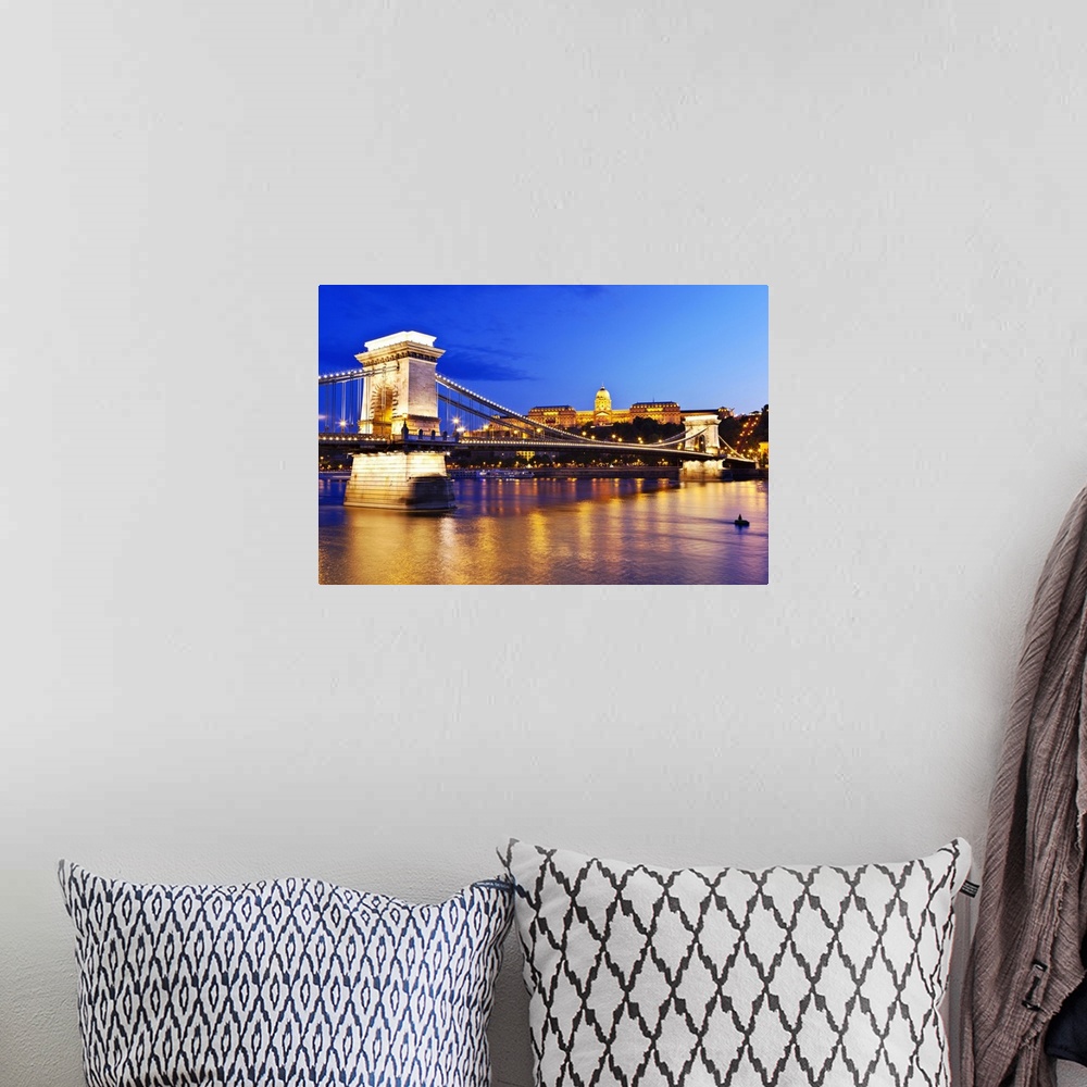 A bohemian room featuring A view of the Chain Bridge over the river Danube at night.
