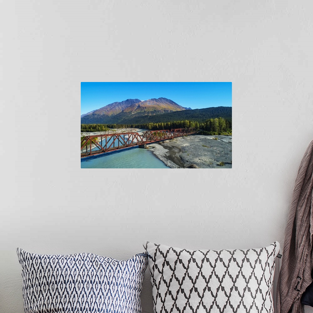 A bohemian room featuring An aerial scenic of the Alaskan Railroad trestle crossing the Snow River on a sunny summer day in...