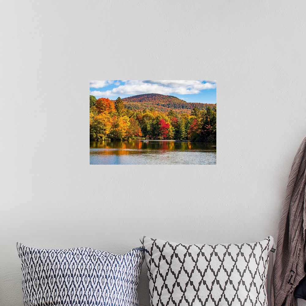 A bohemian room featuring Autumn coloured trees in a forest around a small lake, Sally's Pond, Quebec, Canada.