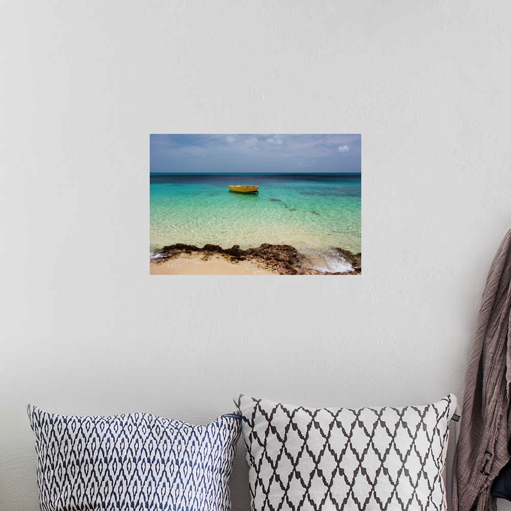 A bohemian room featuring A lone boat in the turquoise water off a tropical island, Frederiksted, St. Croix, Virgin Islands...