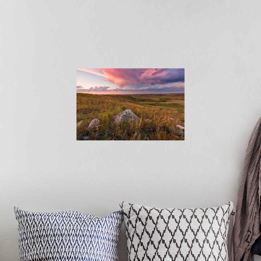 A bohemian room featuring Clouds Lit At Sunset With Some Glacial Erratics Lying In Grasslands National Park;Saskatchewan Ca...