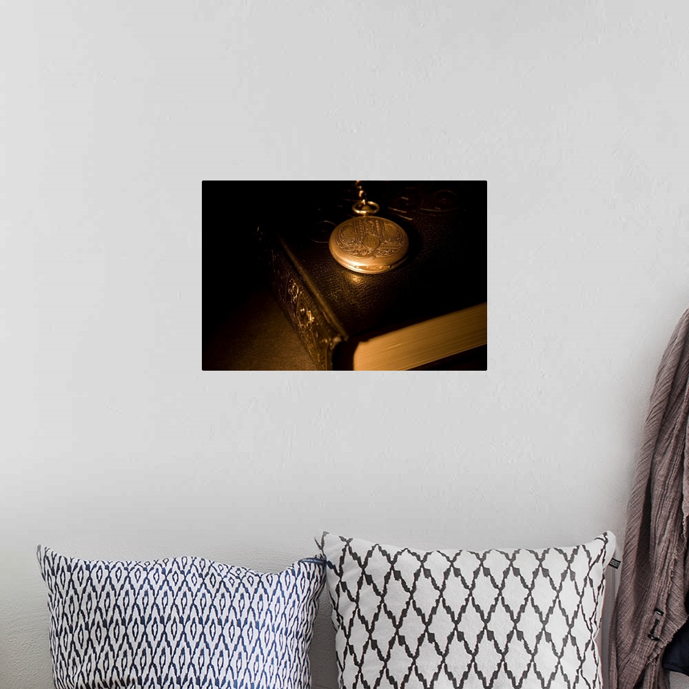 A bohemian room featuring Gold Pocket Watch Resting On A Book