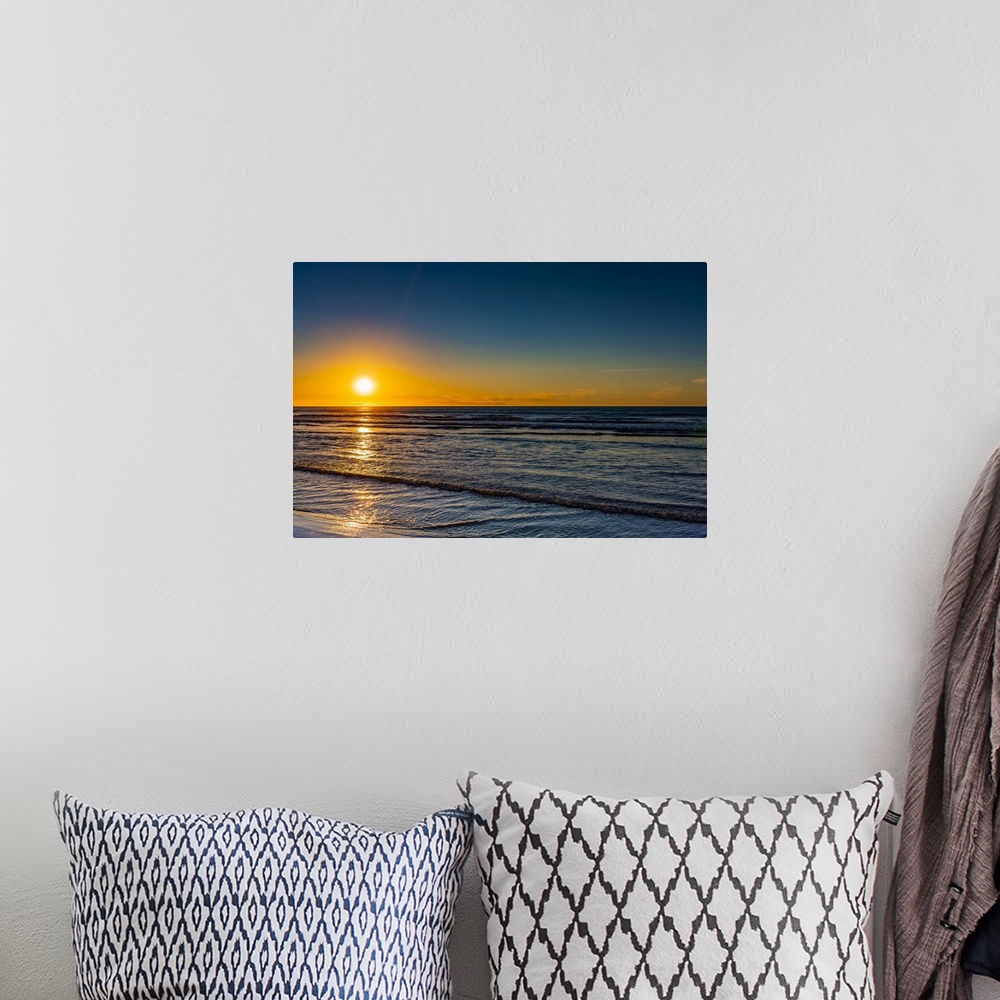 A bohemian room featuring Golden sunset over the Pacific ocean, viewed from the North shore; New Zealand