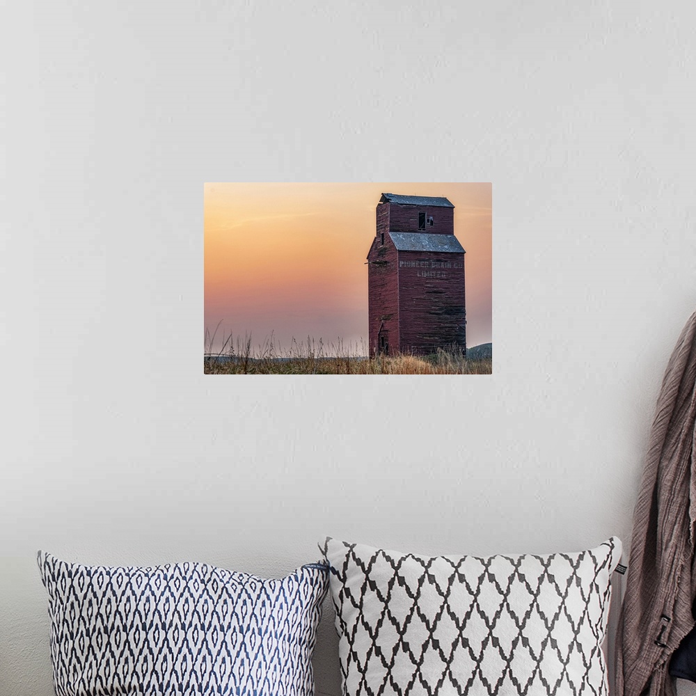 A bohemian room featuring Abandoned and weathered grain elevator at sunset on the Canadian Prairies; Val Marie, Saskatchewa...