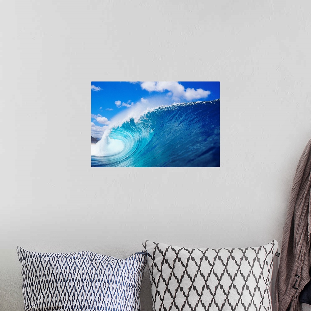 A bohemian room featuring Photograph taken from the side view of a large wave that has begun to curl.