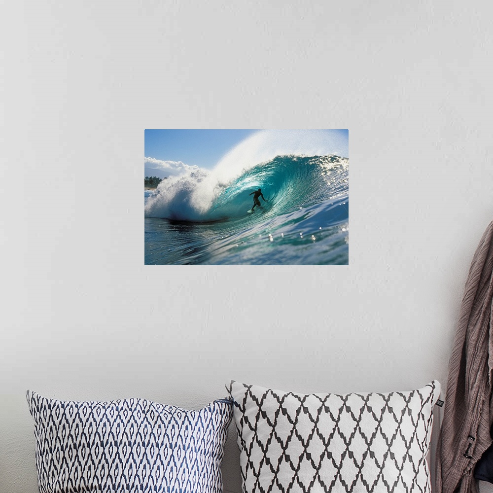 A bohemian room featuring Oversized, landscape photograph of a surfer riding down the center of Pipeline Wave, in the blue ...