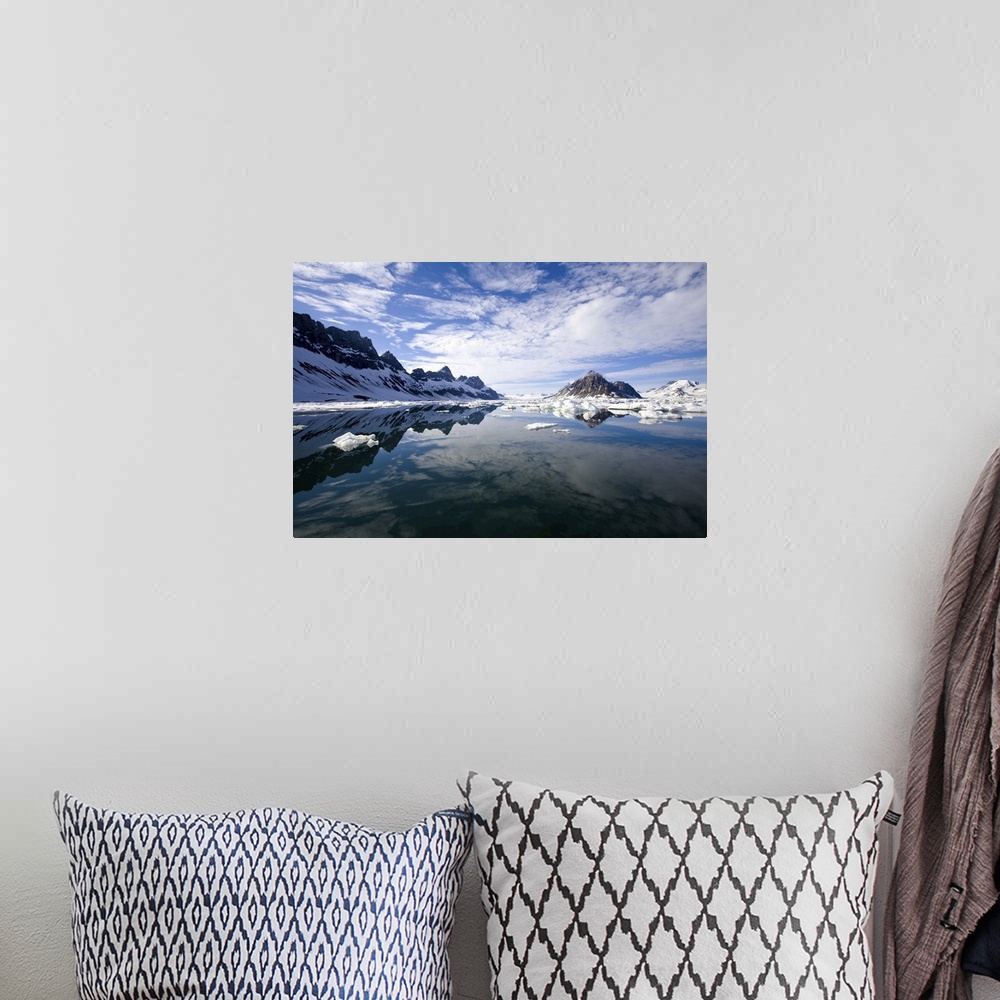 A bohemian room featuring Jagged coastal peaks casting reflections in cold Arctic waters.