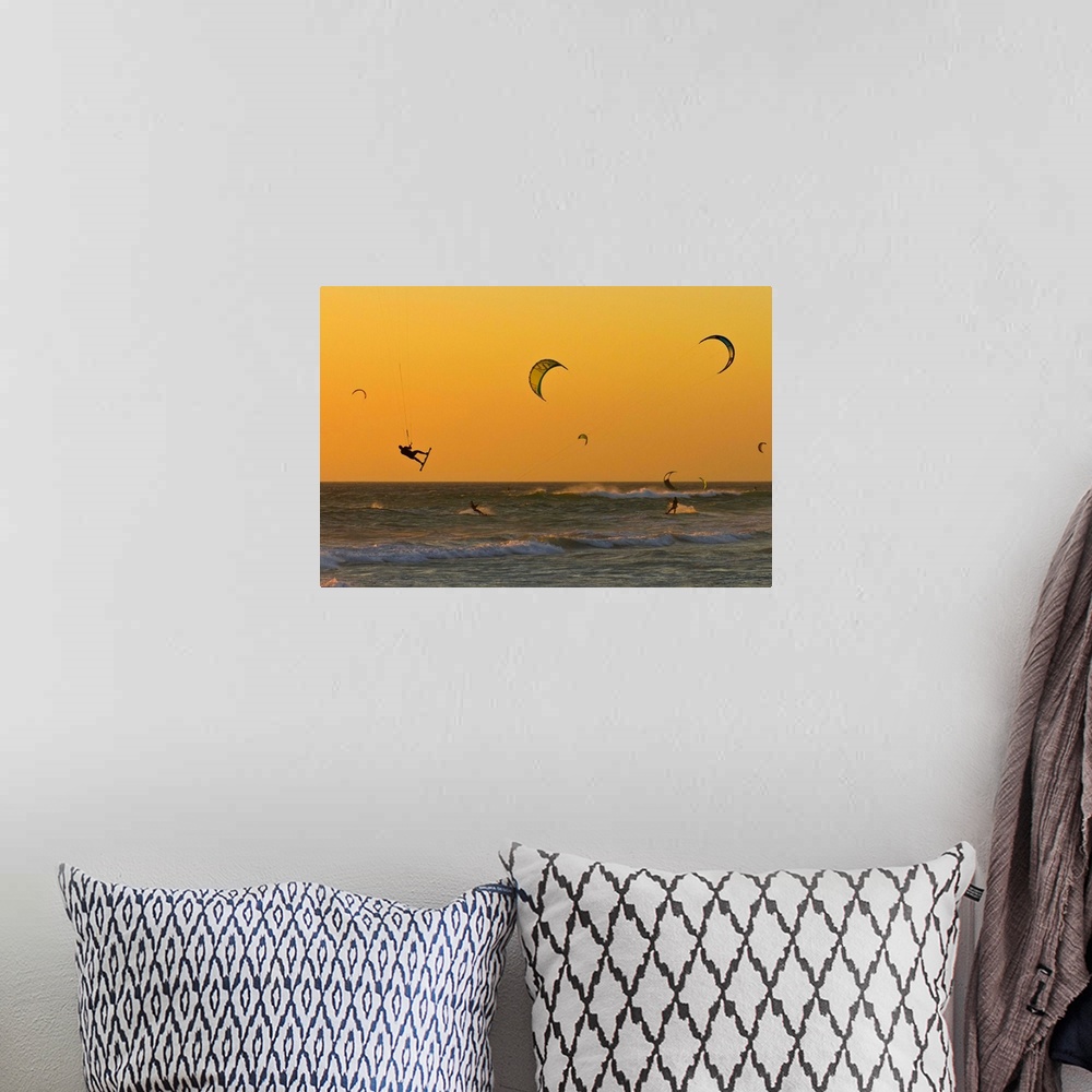 A bohemian room featuring Kite surfers at sunset.