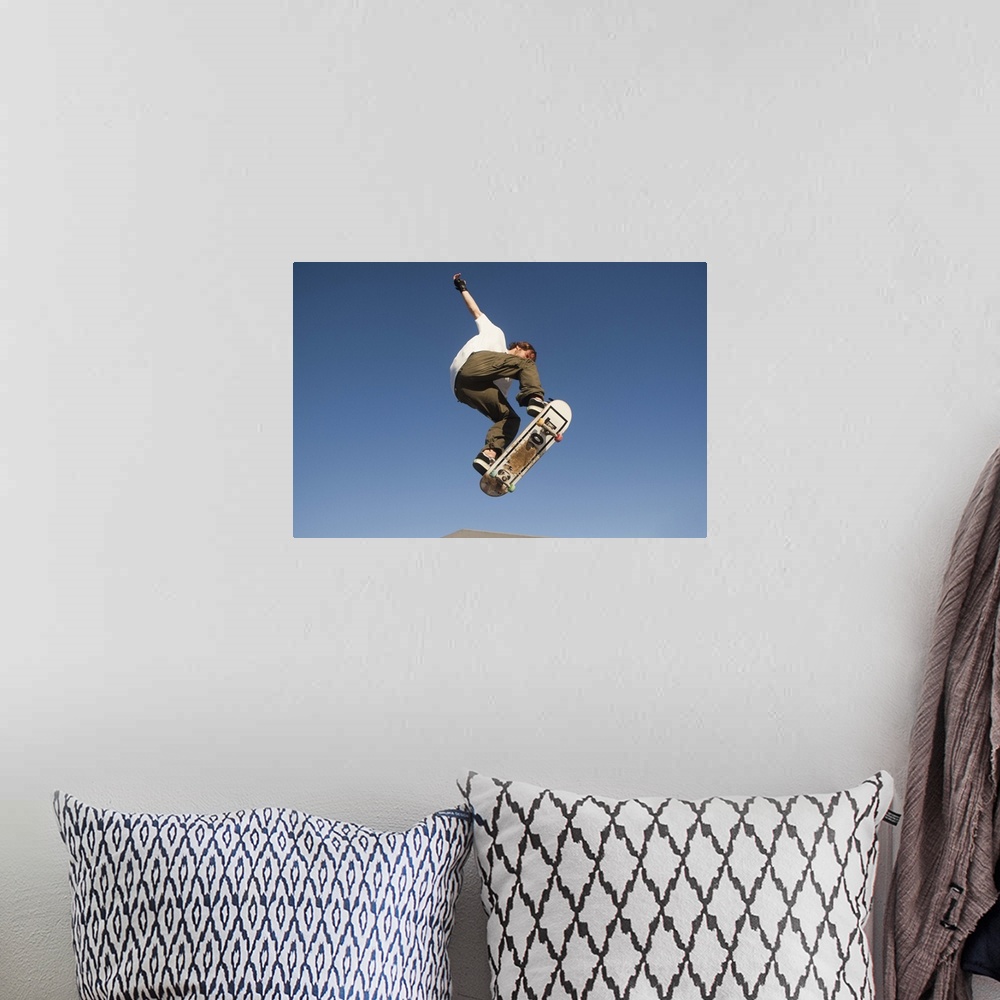 A bohemian room featuring Low Angle View Of Young Male Skateboarder