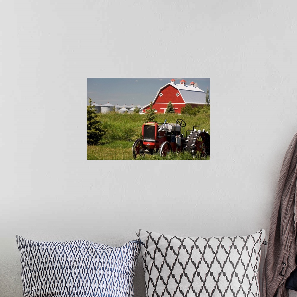 A bohemian room featuring Old Red Tractor In A Field With A Red Barn In The Background, Alberta, Canada