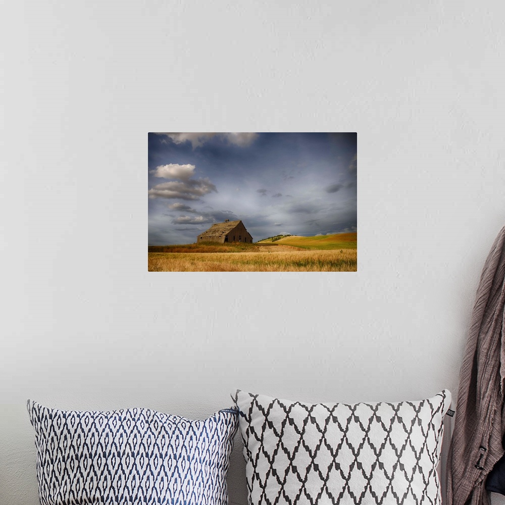 A bohemian room featuring Old wooden barn in a wheat field under a cloudy sky, Palouse, Washington, United States of America.
