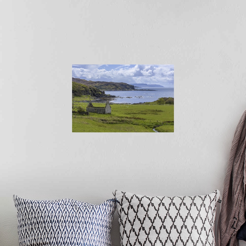 A bohemian room featuring Remains of a stone house in grassy field along the coast on the Isle of Skye in Scotland, United ...