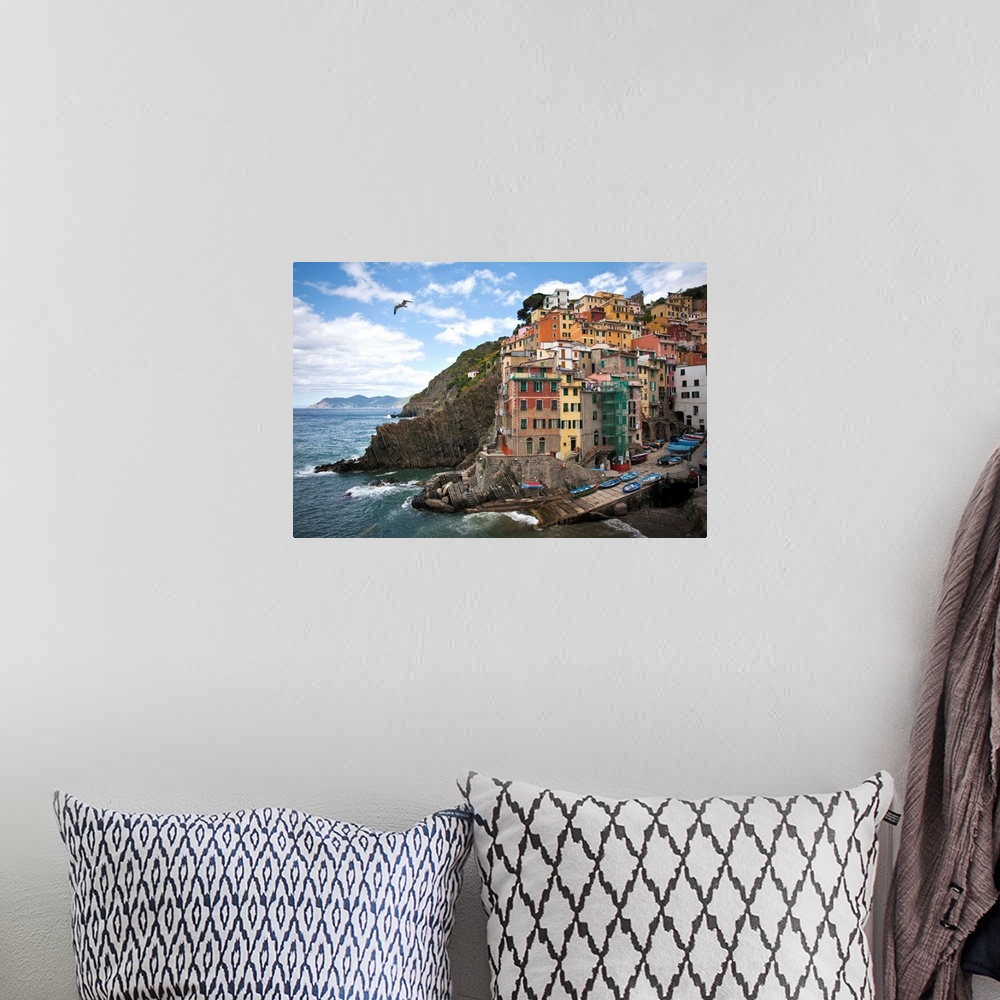 A bohemian room featuring Riomaggiore perched on an outcrop above the sea.
