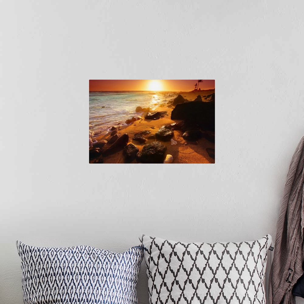 A bohemian room featuring Photograph taken of a sunset on the ocean horizon with various rocks spread out on the beach in t...