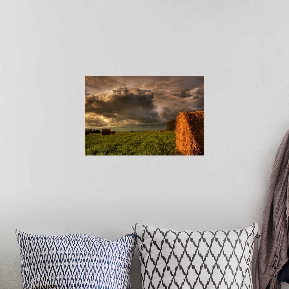 A bohemian room featuring Rolled Hay Bales Under Storm Clouds, Alberta, Canada
