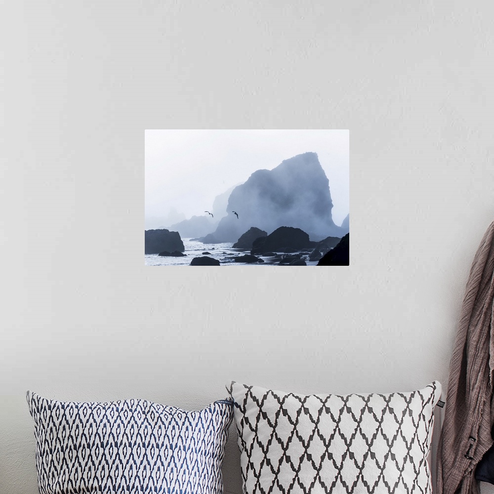 A bohemian room featuring Sea stacks are silhouetted against fog at Ecola state park, cannon beach, Oregon, united states o...