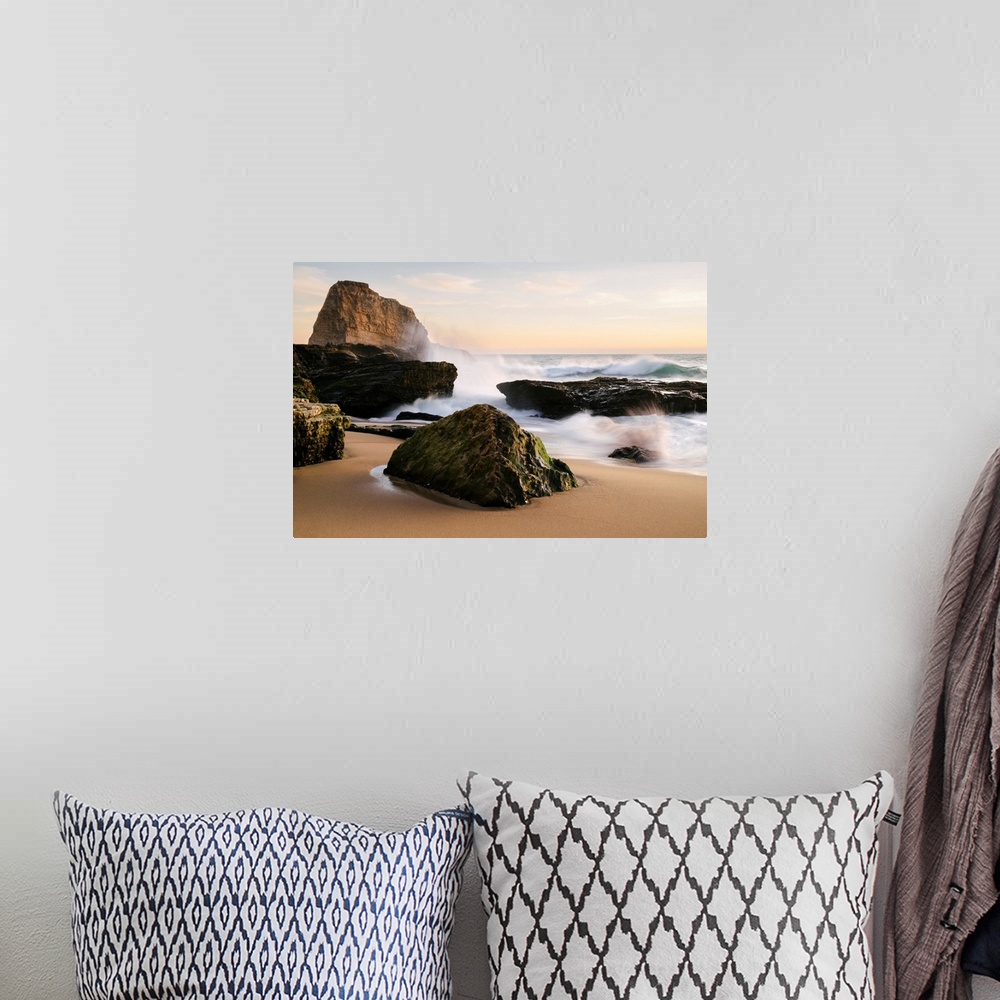 A bohemian room featuring Sunset along the central California coast with waves crashing onto the large rocks on the beach S...