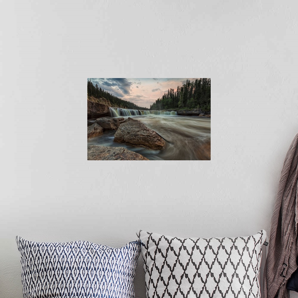 A bohemian room featuring The Trout River Flows Over Sambaa Deh Falls In Sambaa Deh Territorial Park, Northwest Territories...