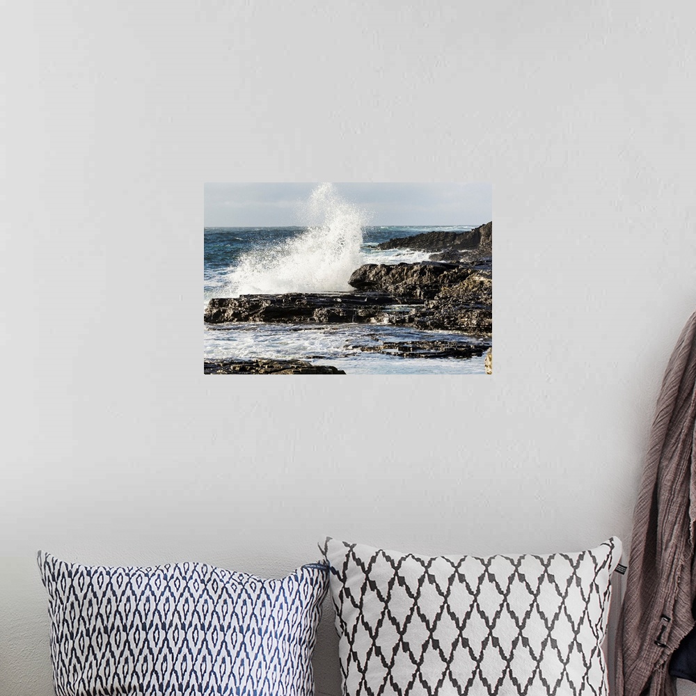 A bohemian room featuring Wave crashing into rocky coast with cloudy sky, Kilkee, County Clare, Ireland
