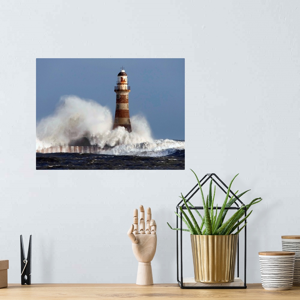 A bohemian room featuring Waves Crashing Against A Lighthouse; Sunderland, Tyne And Wear, England