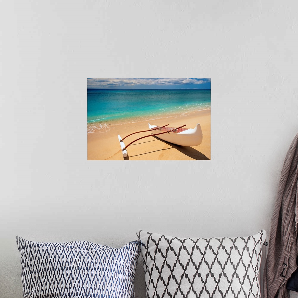 A bohemian room featuring Horizontal canvas of a canoe sitting on a beach with crystal clear water washing ashore from the ...