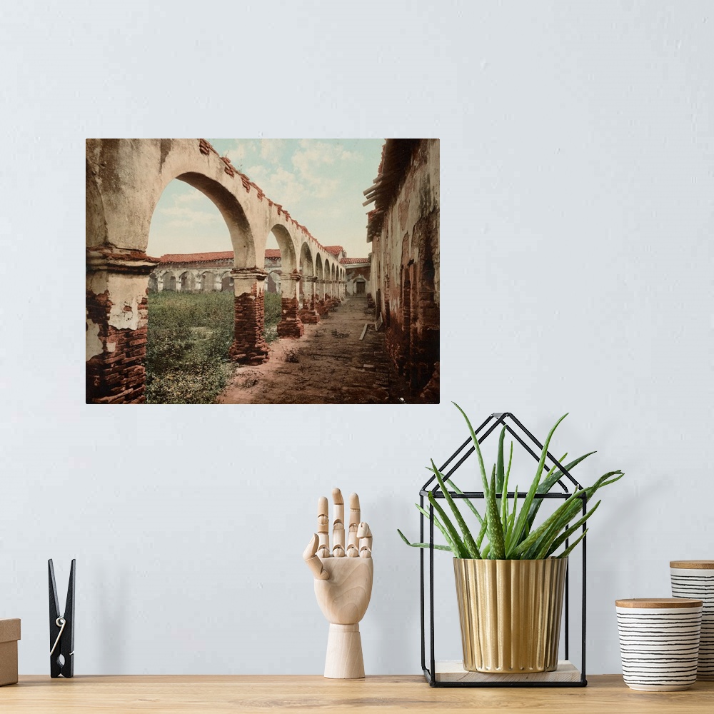 A bohemian room featuring Hand colored photograph of mission San Juan Capistrano, California.