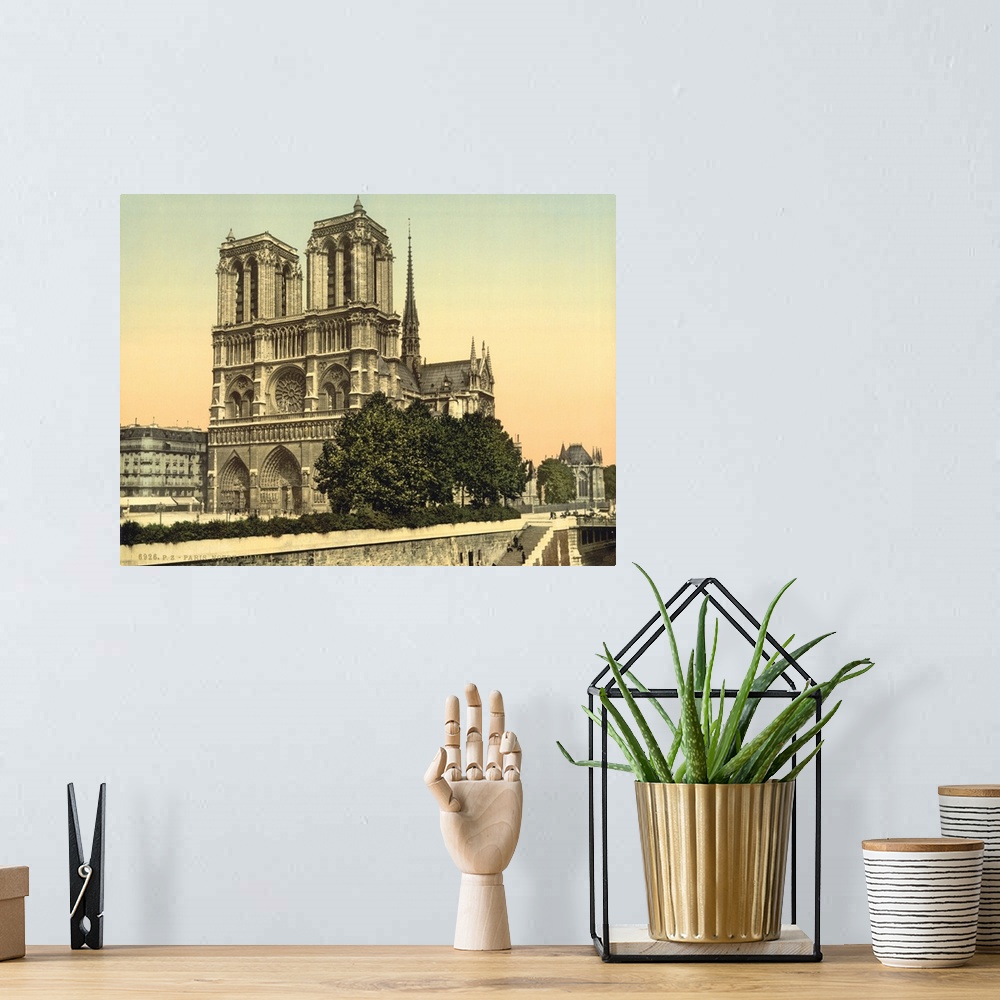 A bohemian room featuring Hand colored photograph of Notre dame, Paris, France.