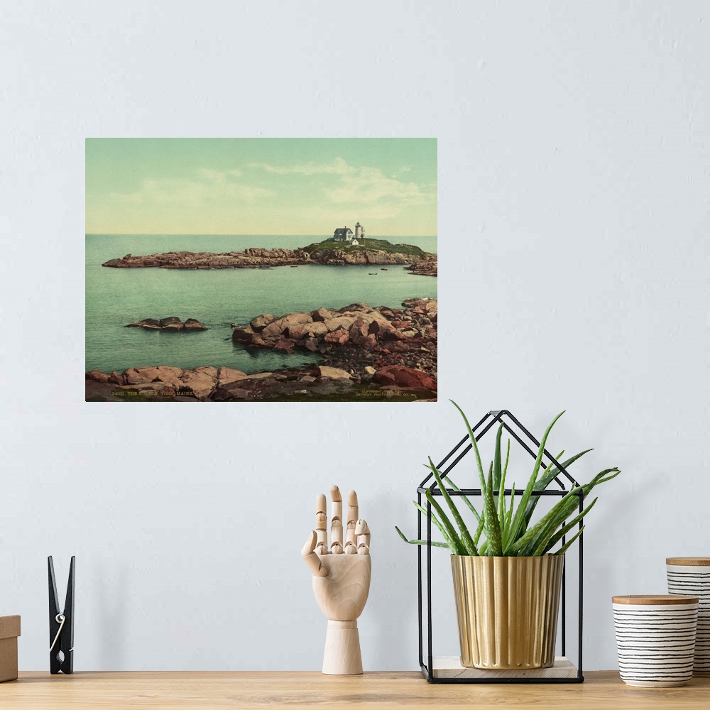 A bohemian room featuring Hand colored photograph of the nubble, York, Maine.