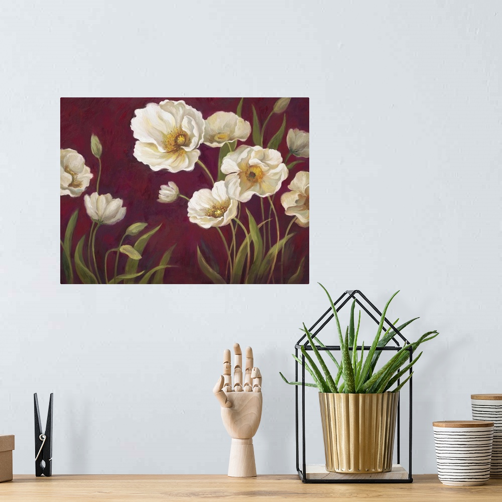 A bohemian room featuring Home decor artwork of white poppies against a deep red background.