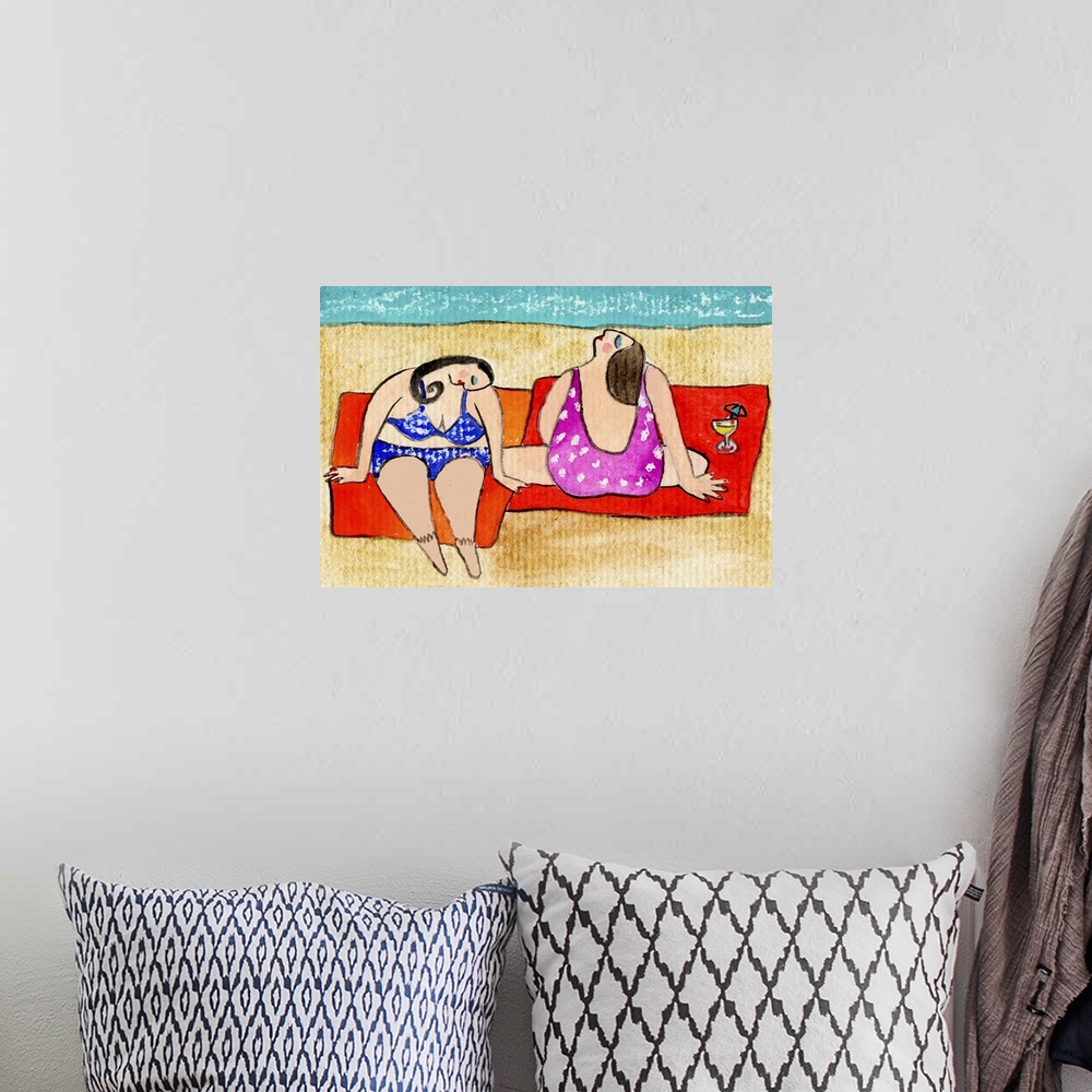 A bohemian room featuring Two women in swimsuits sitting near the ocean on red towels.