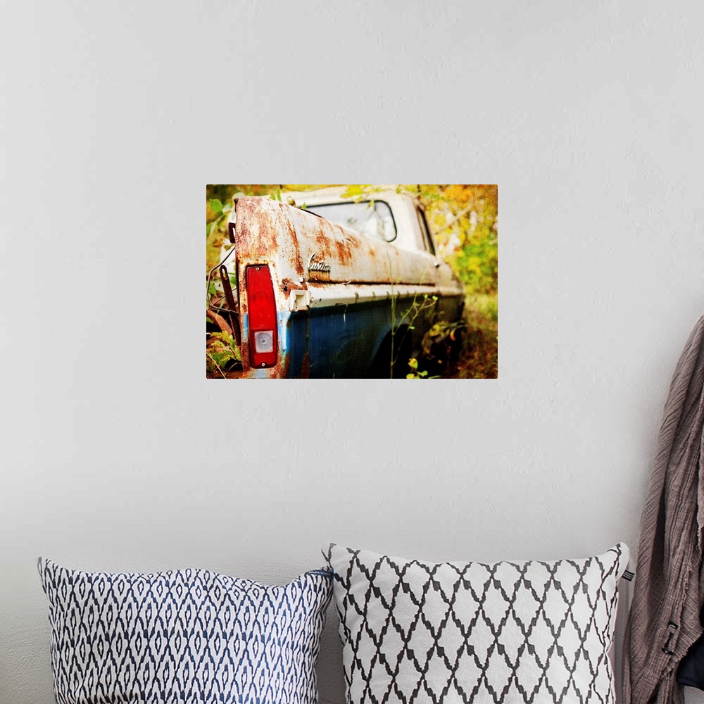 A bohemian room featuring Photograph of a derelict truck in the woods.