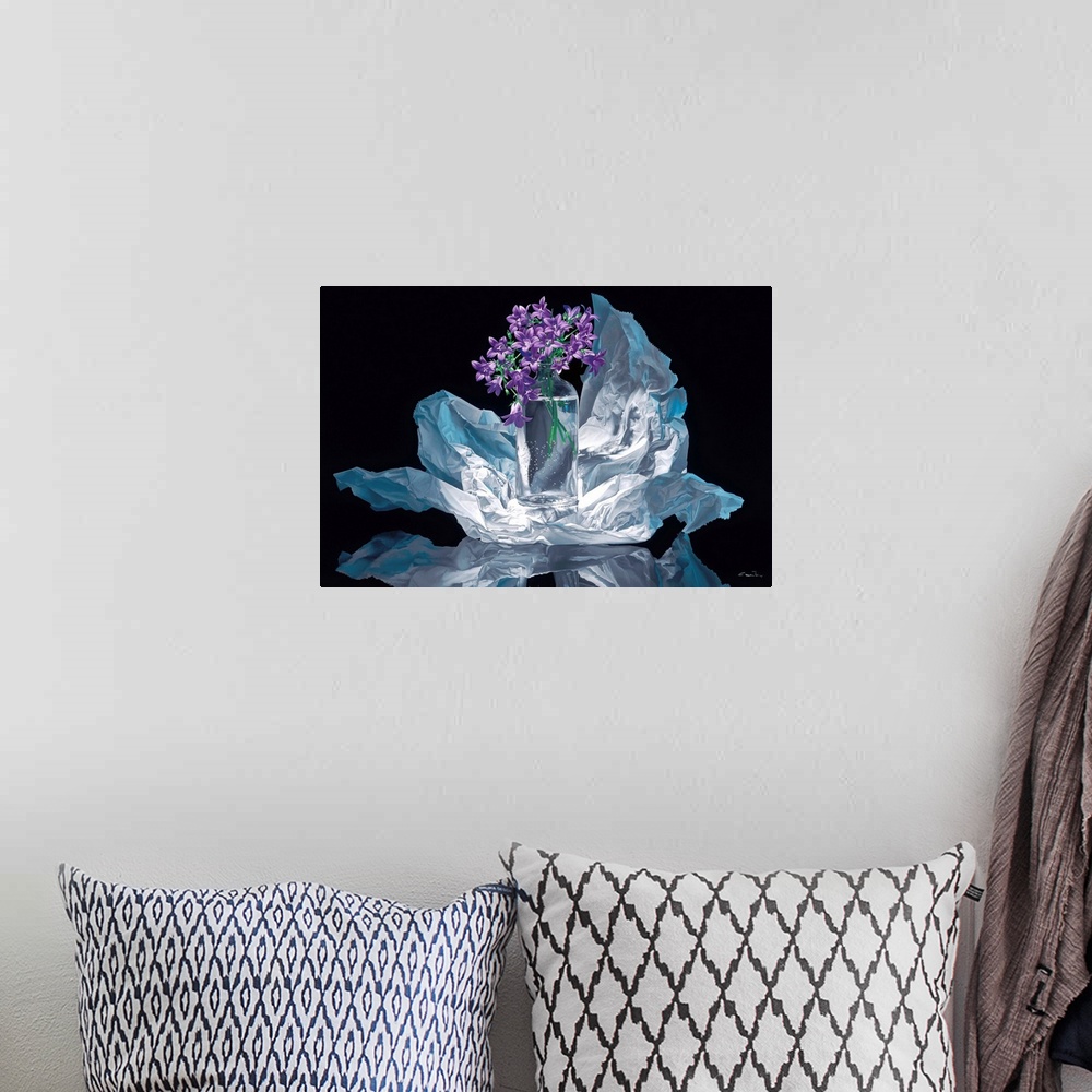 A bohemian room featuring Contemporary vivid realistic still-life painting of a clear glass vase holding purple flowers, wh...