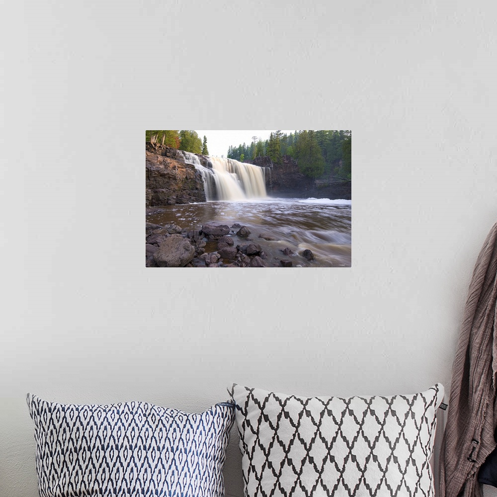 A bohemian room featuring Photograph of a waterfall caught in motion blur surrounded by forest.