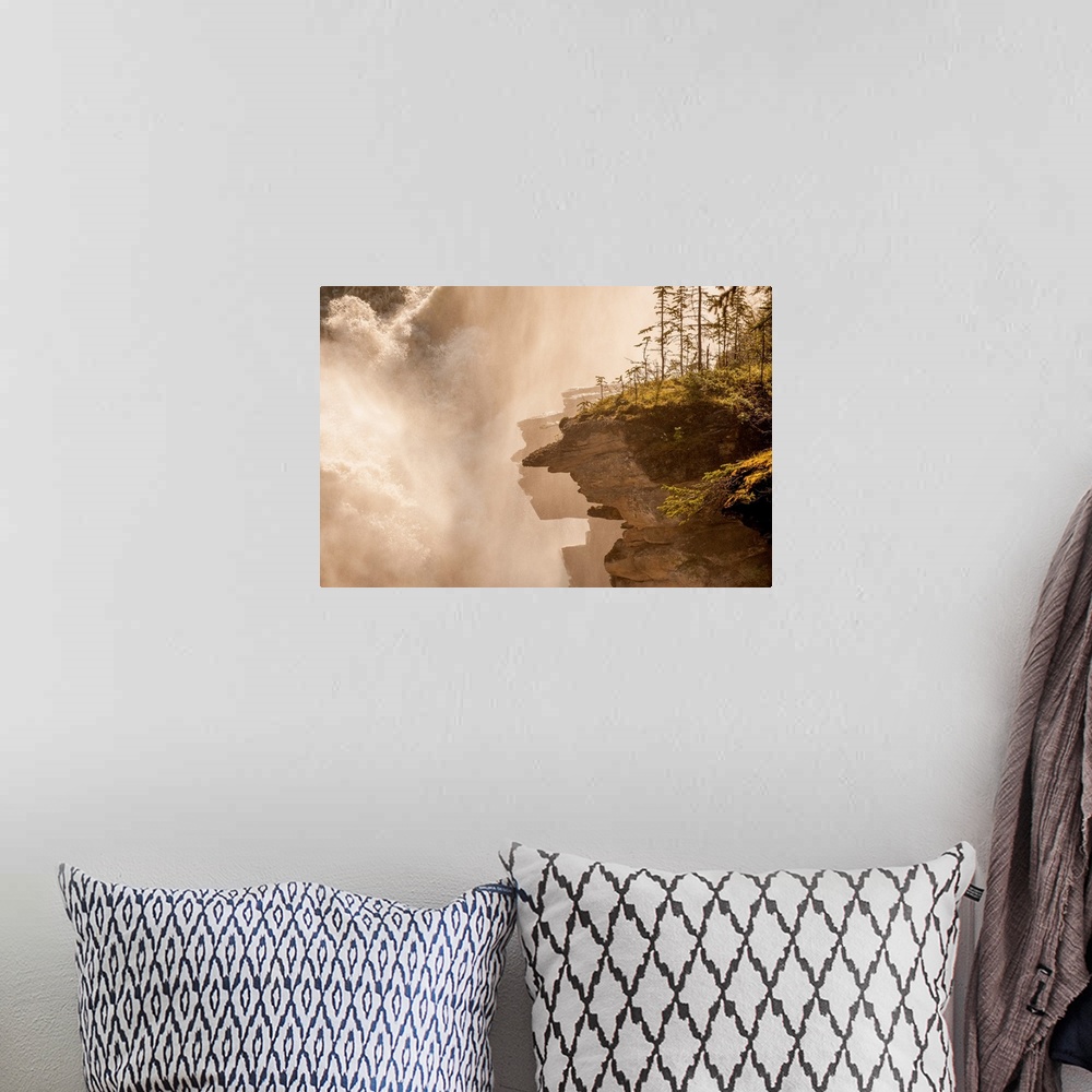 A bohemian room featuring Misty photograph of rocky cliffs next to a large, rushing waterfall.