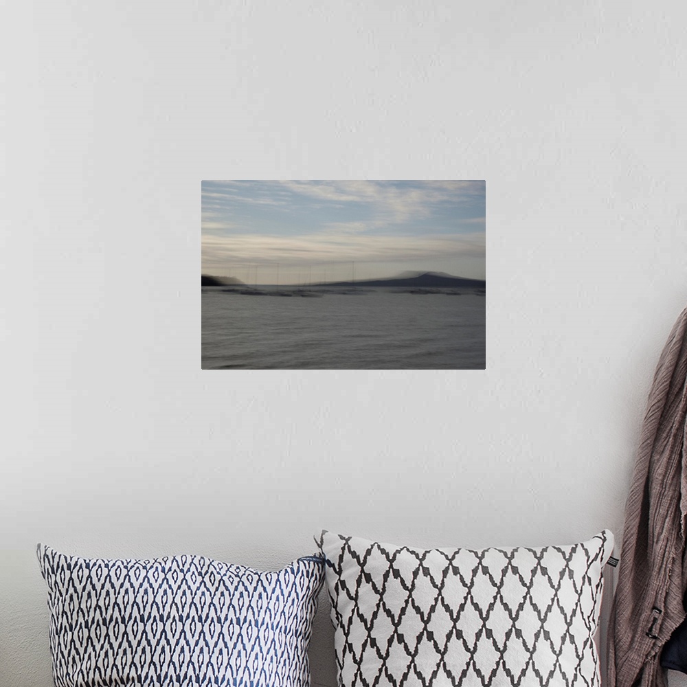 A bohemian room featuring Impressionist photograph by the seaside.