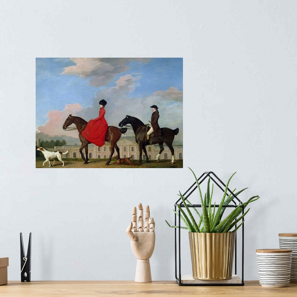 A bohemian room featuring Classic artwork of a man and a woman riding their horses with their two dogs running along side t...