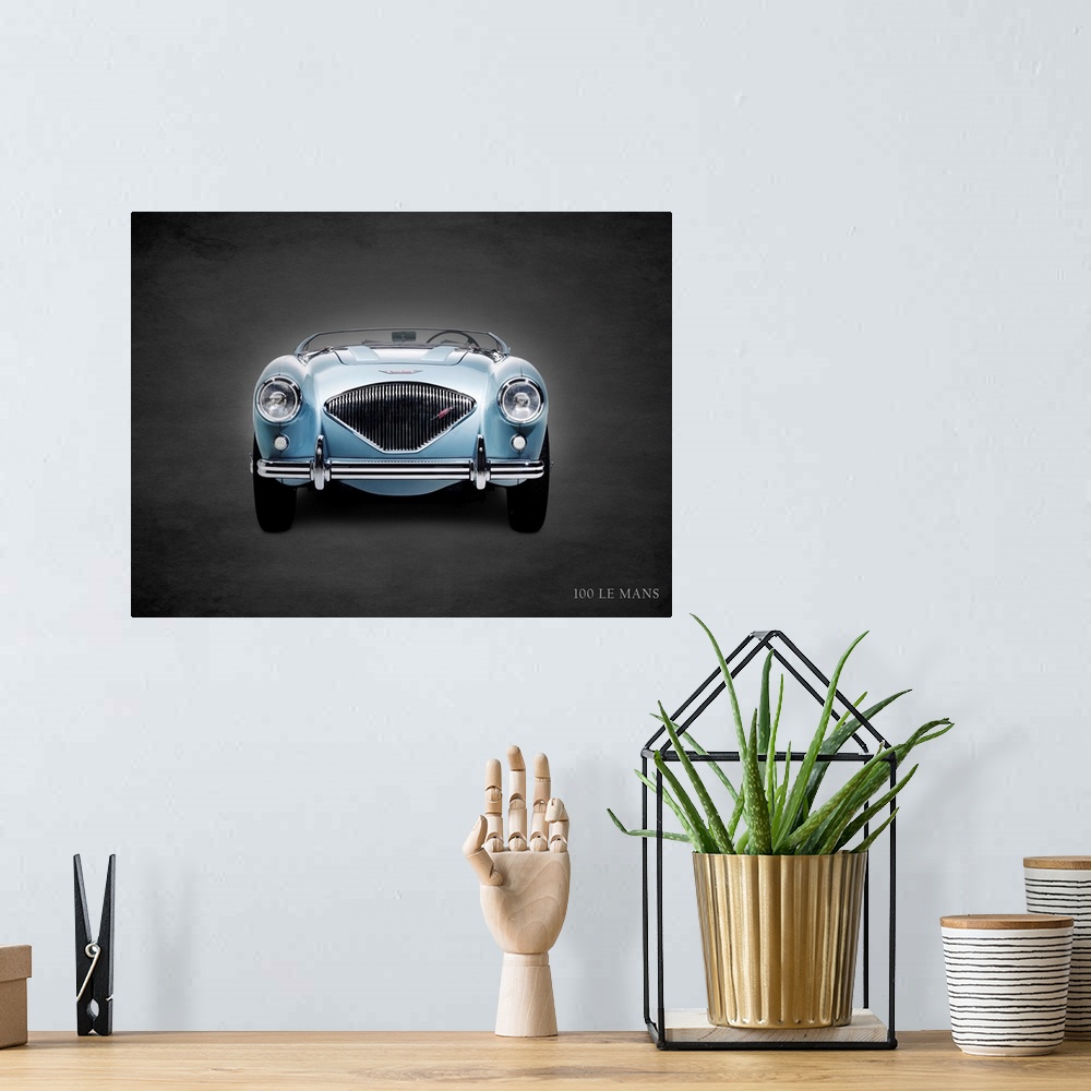 A bohemian room featuring Photograph of a powder blue 1956 Austin-Healey 100 LeMans printed on a black background with a da...