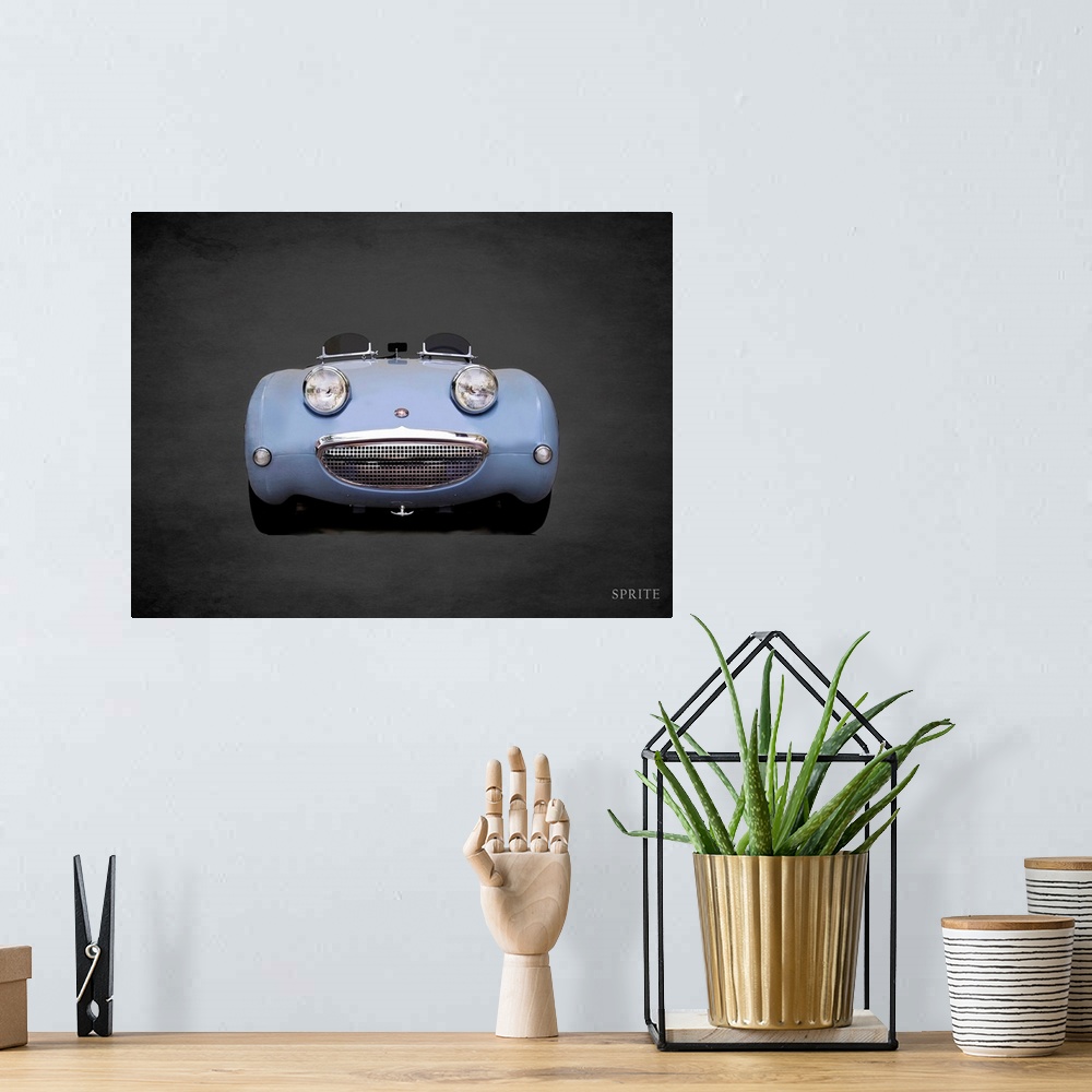 A bohemian room featuring Photograph of a powder blue Austin-Healey Sprite Mk1 printed on a black background with a dark vi...