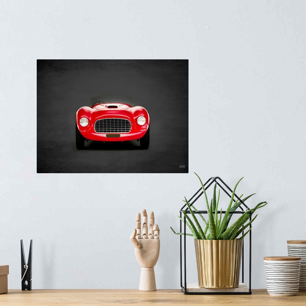 A bohemian room featuring Photograph of a red 1948 Ferrari 166 printed on a black background with a dark vignette.