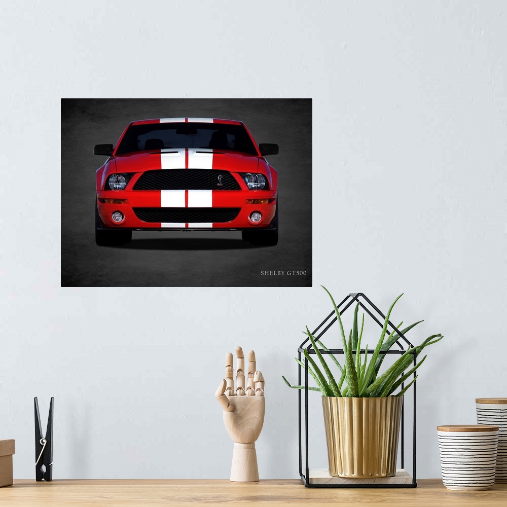 A bohemian room featuring Photograph of a red Ford Shelby GT500 with white stripes printed on a black background with a dar...