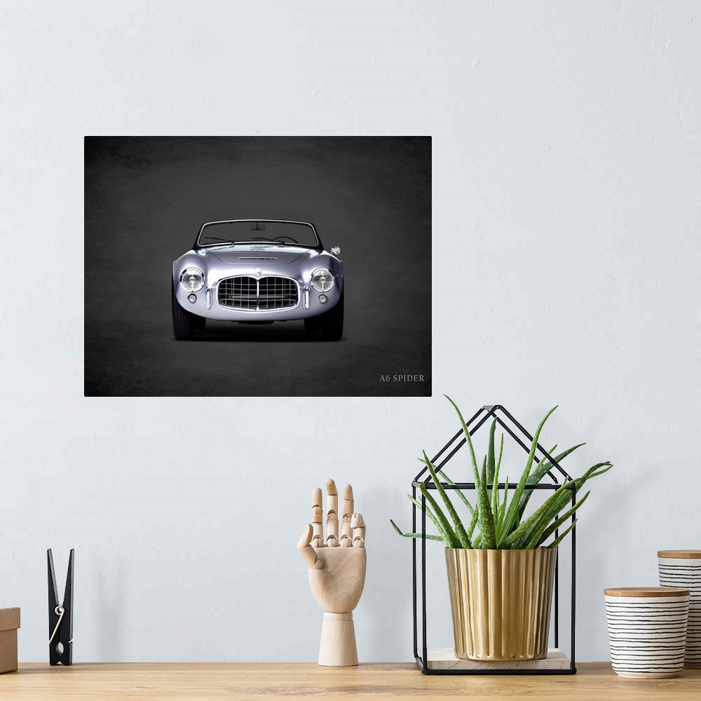 A bohemian room featuring Photograph of a silver Maserati A6 Spider printed on a black background with a dark vignette.