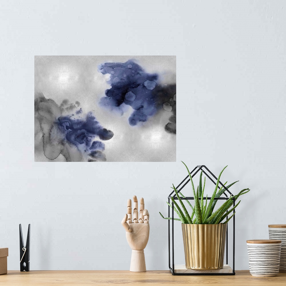 A bohemian room featuring Abstract painting with indigo and black hues splattered together on a silver background.