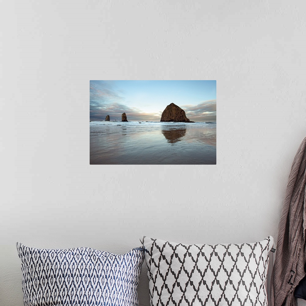 A bohemian room featuring Photograph of large rocks along the coastline of a beach.