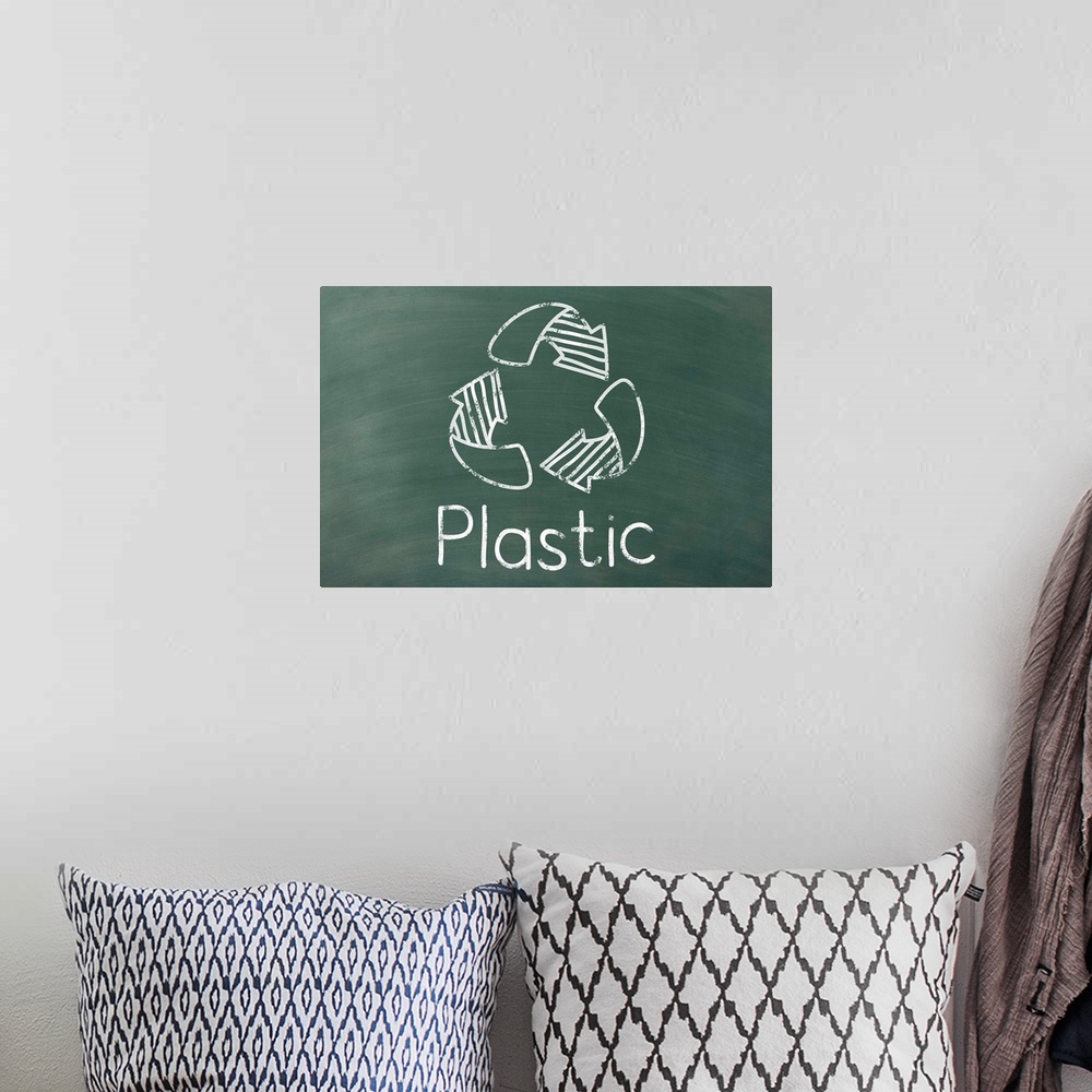 A bohemian room featuring Recycling symbol with "Plastic" written underneath in white on a green chalkboard background.