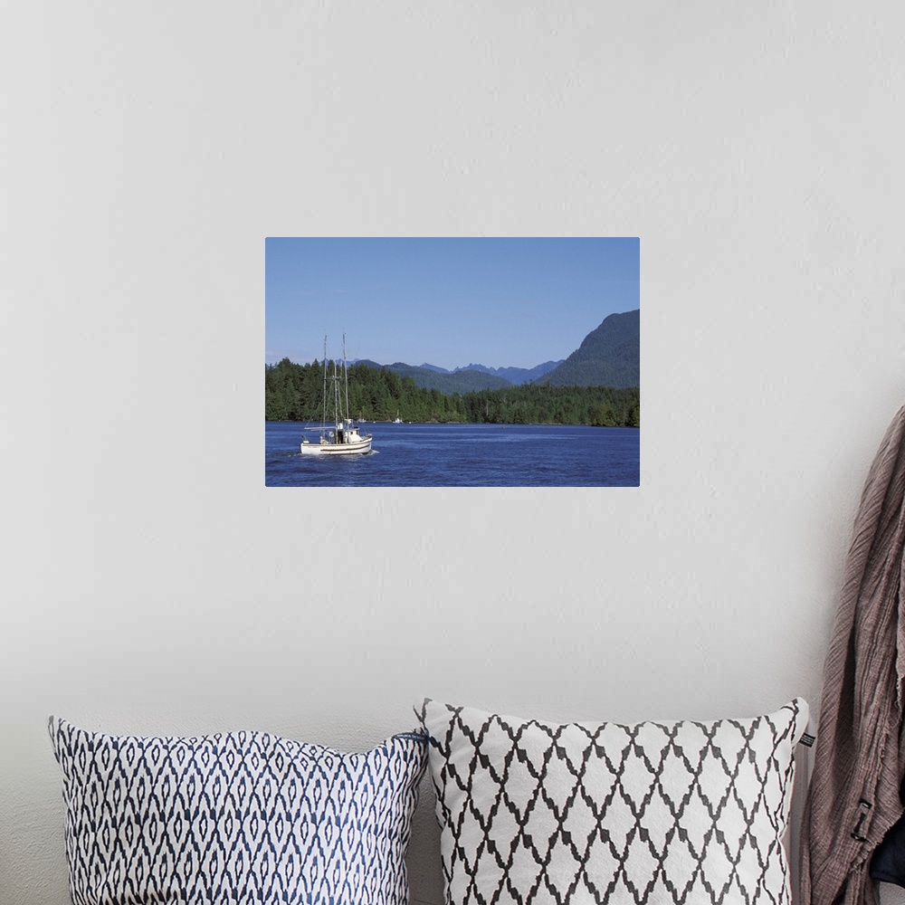 A bohemian room featuring Canada, British Columbia, Vancouver Island.Fishing boat from Tofino harbor into Clayoquot Sound